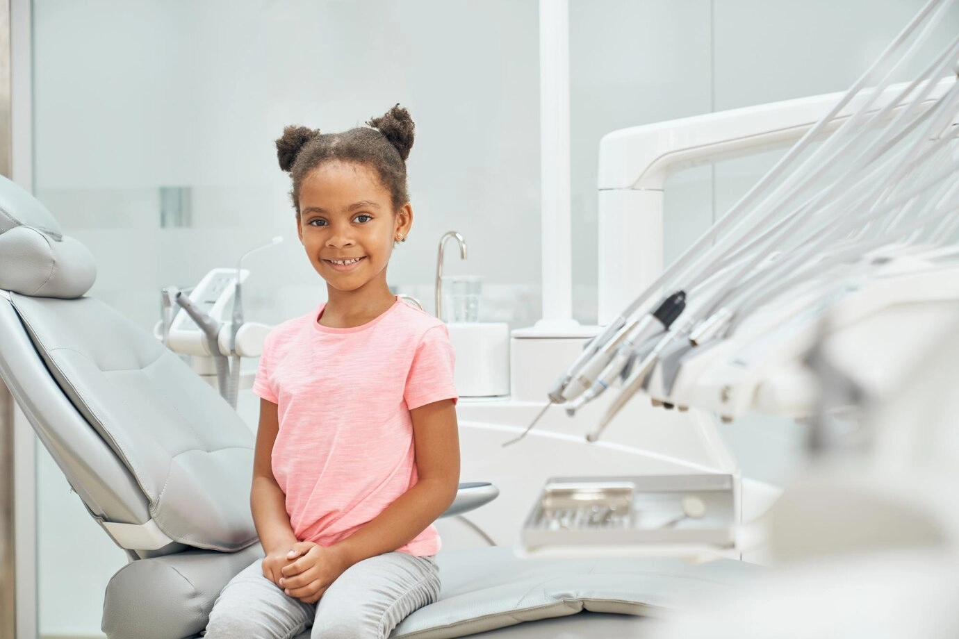girl sitting in the dentist chair for pediatric dental care